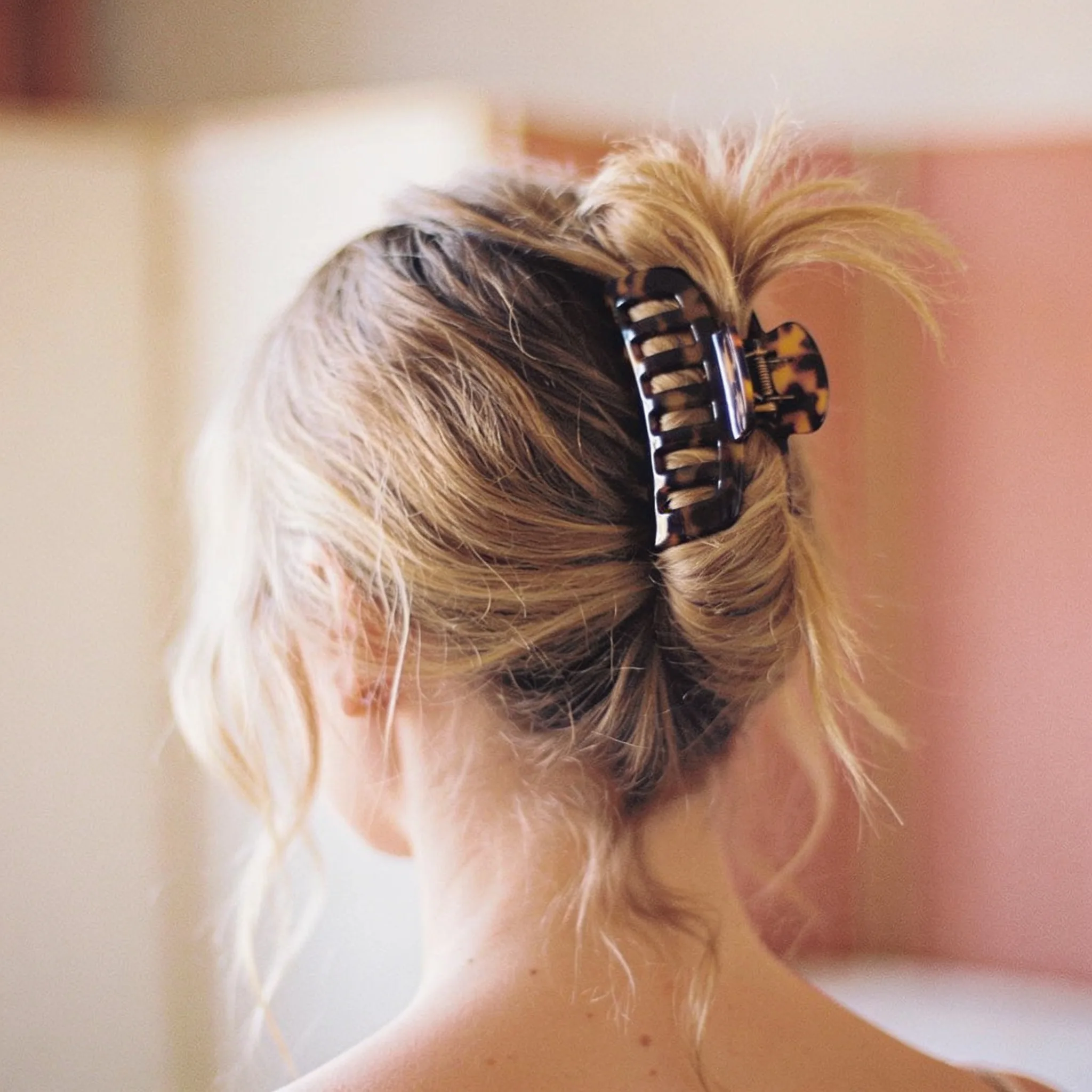 Soft lived-in blonde pinned up with a tortoiseshell clip
