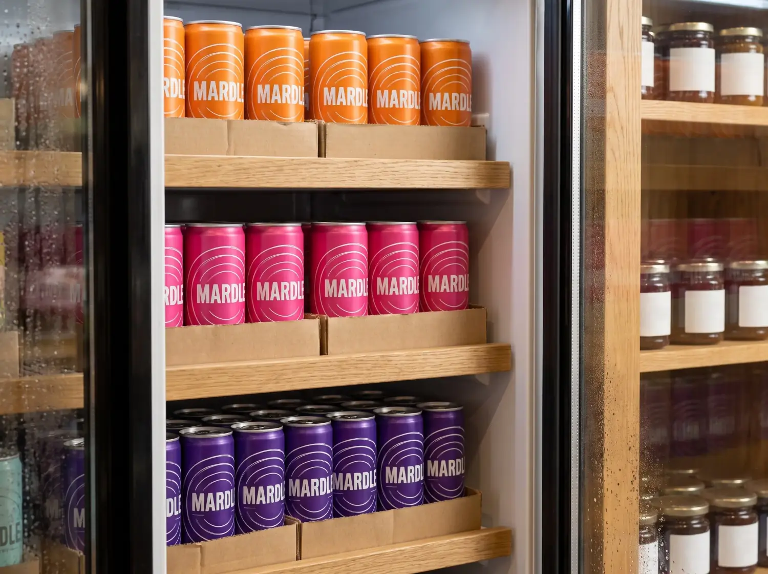 A chilled cabinet in a Suffolk farm shop, rows of orange and pink Mardle stacked in card trays behind misted glass