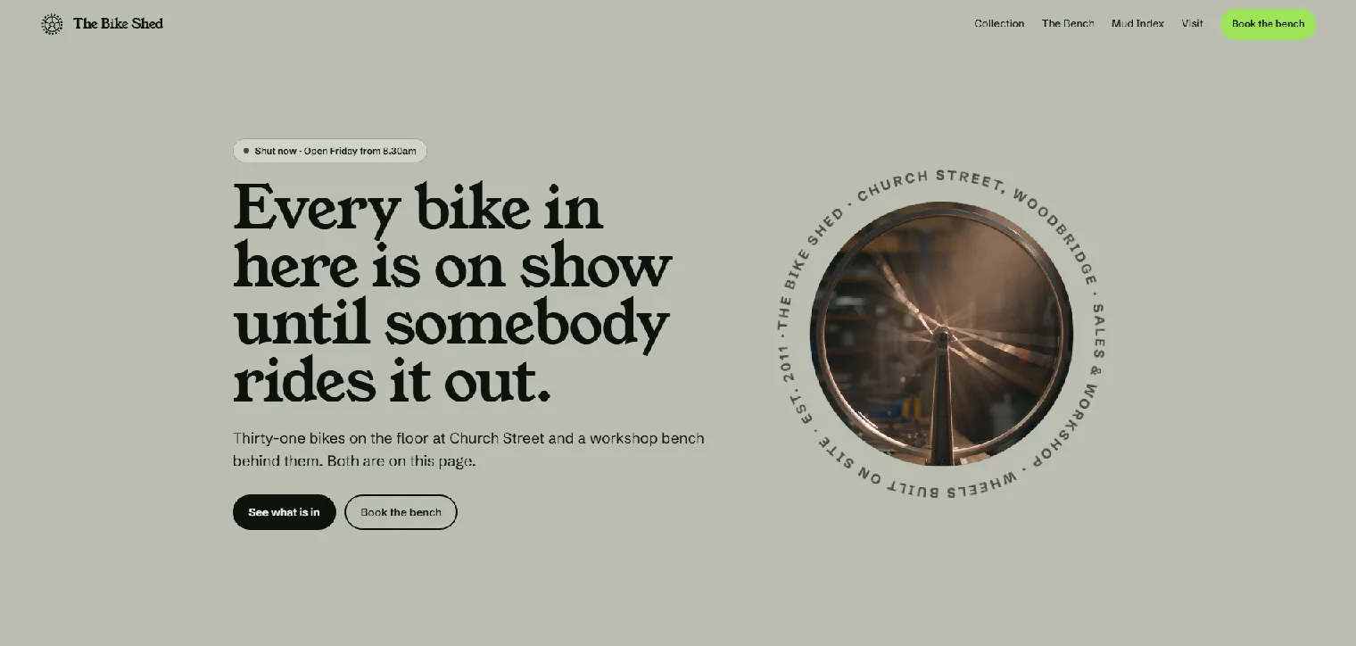 The Bike Shed homepage, a workshop wheel spinning inside a circular band of type beside an Every bike in here is on show until somebody rides it out headline